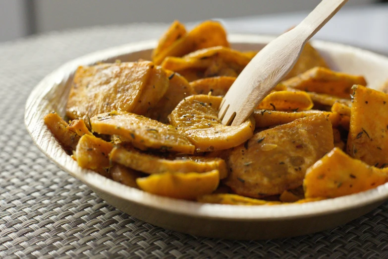 a close up of a bowl of food on a table, slices of orange, slide show, square, battered