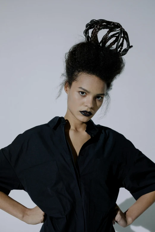 a woman standing with her hands on her hips, an album cover, unsplash, bauhaus, black iron crown, nonbinary model, tessa thompson inspired, in a halloween style