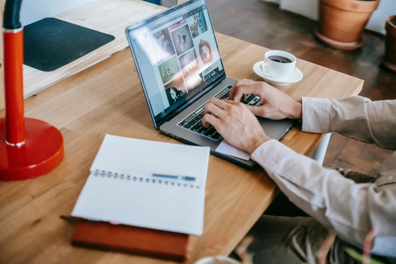 a man sitting at a desk using a laptop computer, trending on pexels, bottom angle, cardboard, some people are sitting, middle of the page