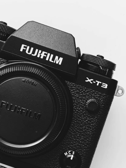 a black camera sitting on top of a white table, by Adam Rex, unsplash contest winner, fujifilm x-t3, rule of thirds, furry shot, close - up photograph