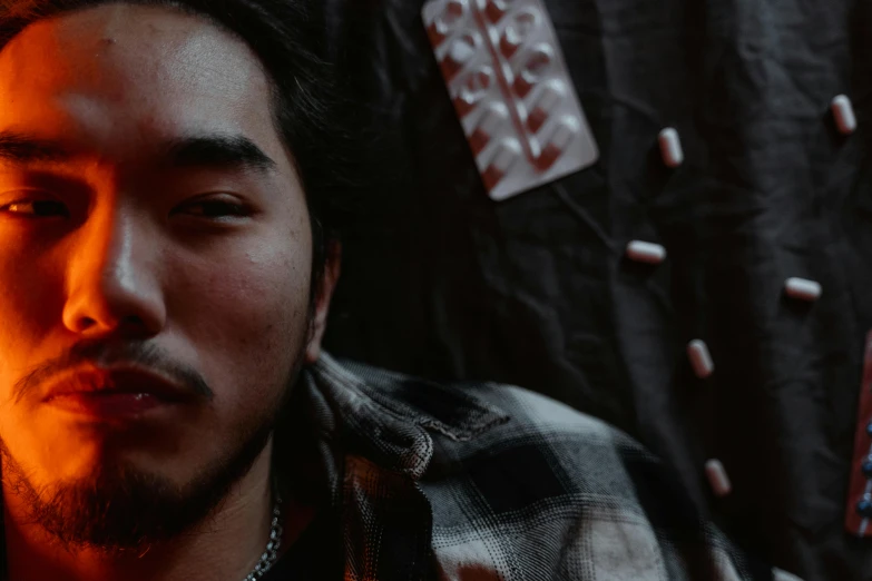 a close up of a person with a cell phone, an album cover, inspired by Liam Wong, pexels contest winner, shin hanga, pills, slightly dirty face, still frame from a movie, sitting down