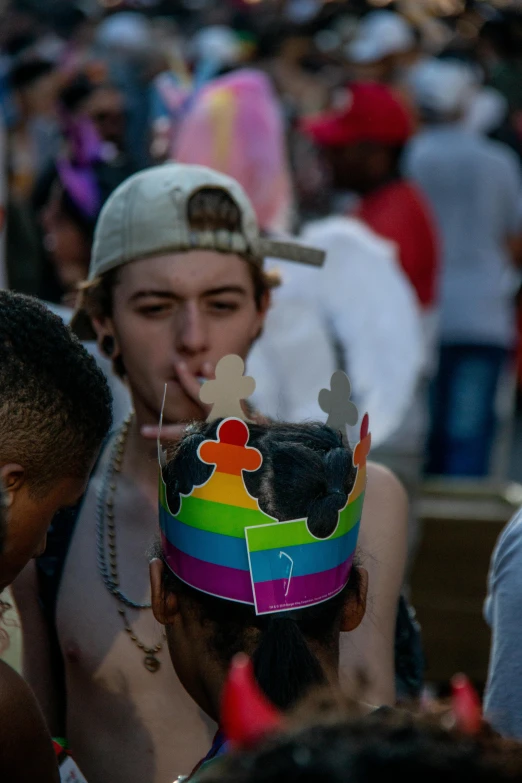 a group of people standing next to each other in a crowd, by Hubert van Ravesteyn, trending on unsplash, wearing a party hat, lgbt, wearing a crown, young male