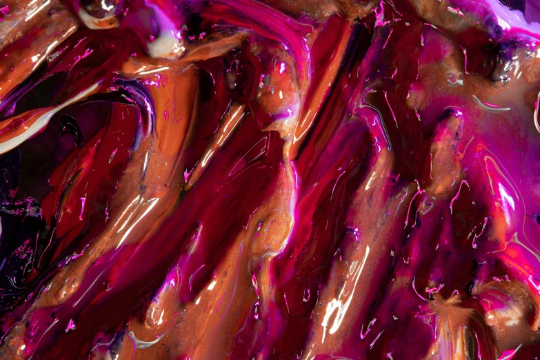 a close up of a chocolate cake covered in pink icing, inspired by Lynda Benglis, trending on pexels, abstract art, red and purple, liquid gold, caramel, oil inks