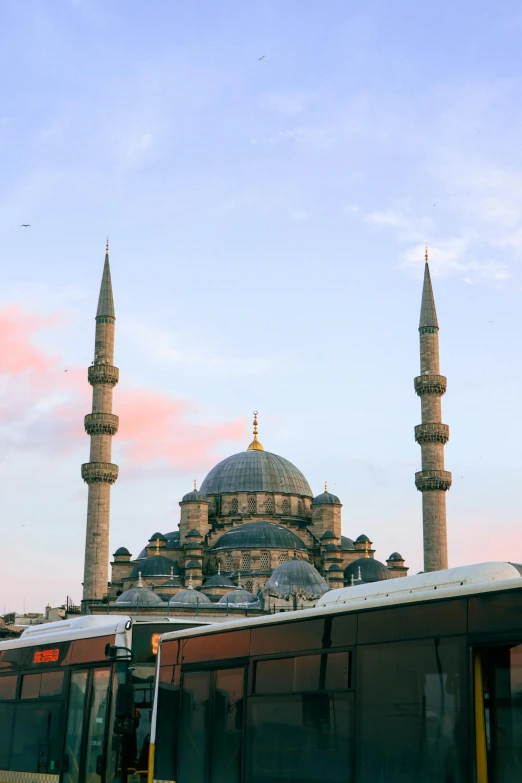 a train that is sitting in front of a building, inspired by Altoon Sultan, trending on pexels, hurufiyya, minarets, sky blue, byzantine, seen from far away