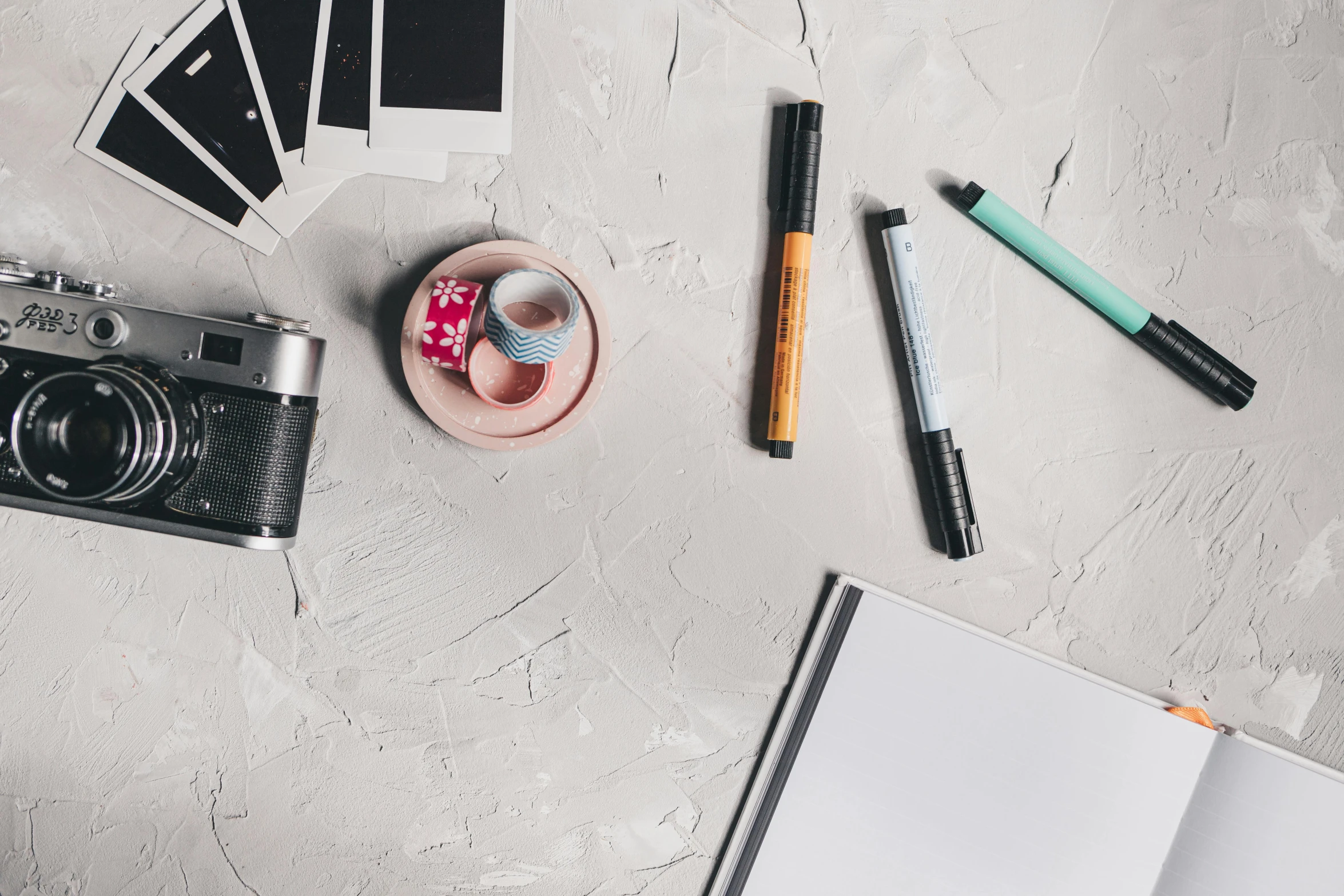 a camera, a cup of coffee, and a notebook on a table, pexels contest winner, arbeitsrat für kunst, markers, on grey background, various posed, cute photo