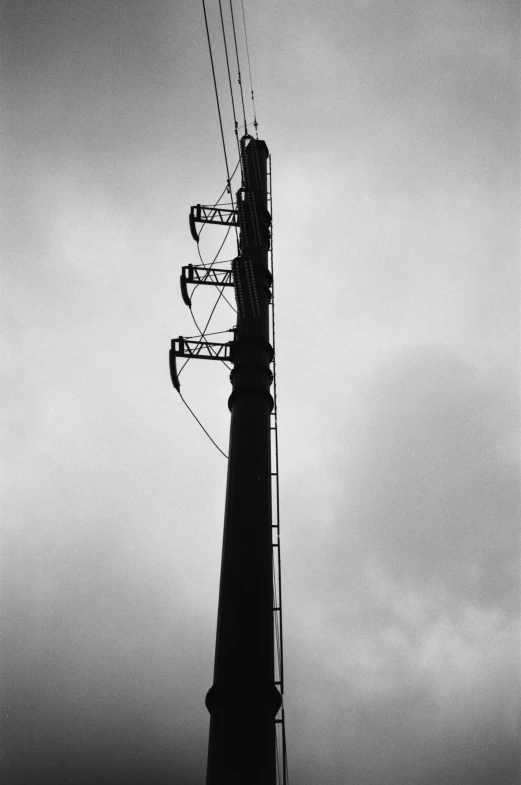 a black and white photo of a telephone pole, inspired by André Kertész, hasselblad photograph, 1996), industrial, spire