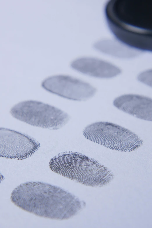 a cell phone sitting on top of a table covered in finger prints, zoomed in, grey, thumbnail, detaling