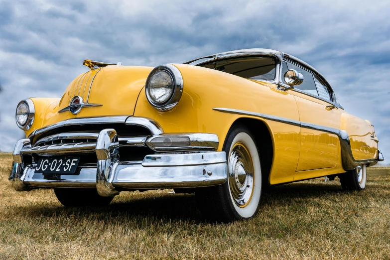 a yellow classic car parked in a field, pexels contest winner, photorealism, “ iron bark, avatar image, carnival, high resolution image