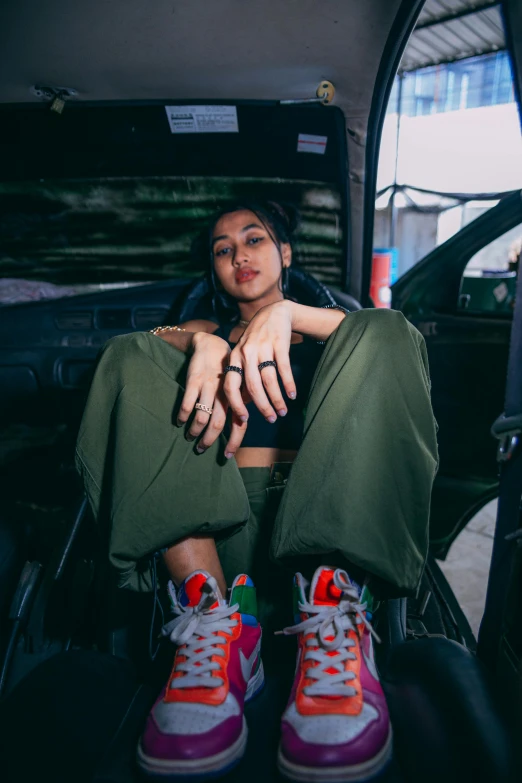 a woman sitting in the back seat of a car, trending on pexels, visual art, wearing cargo pants, assamese aesthetic, ashteroth, portrait pose