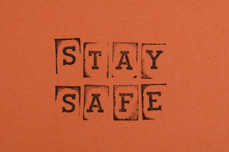 a book with the words stay safe written on it, an album cover, inspired by Ian Hamilton Finlay, pixabay, private press, orange safety labels, intaglio style, in the style wes anderson, brown ) )