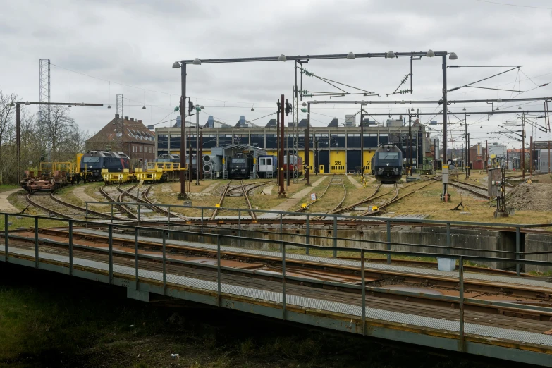 a train yard filled with lots of train tracks, by Jan Tengnagel, happening, 2 0 2 2 photo, trams ) ) ), seen from outside, gemmy woud - binendijk