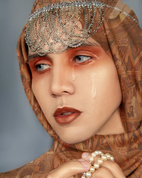 a close up of a woman wearing a headscarf, an album cover, inspired by Sasha Putrya, trending on pexels, hurufiyya, crying makeup, nonbinary model, lgbt, tear drop