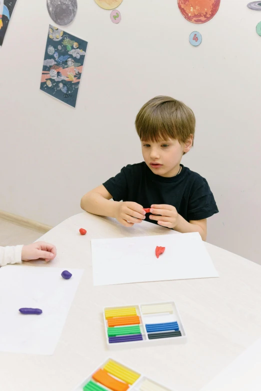 a woman and a child sitting at a table, a child's drawing, inspired by Jan Zrzavý, process art, plasticine models, primary colors are white, boys, thumbnail