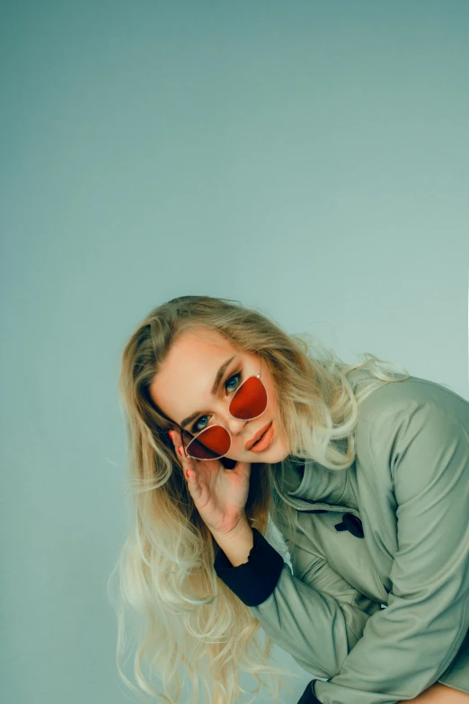 a woman sitting on top of a suitcase, inspired by Elsa Bleda, trending on pexels, red sunglasses, headshot profile picture, blonde swedish woman, heart - shaped face