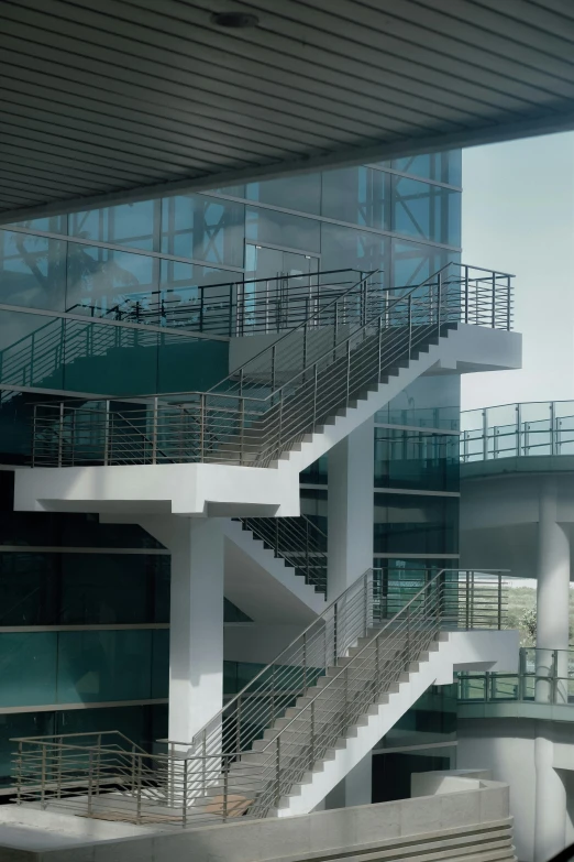 a couple of stairs that are next to a building, executive industry banner, research complex, skybridges, zoomed out shot