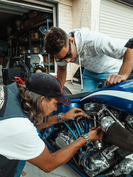 two men working on a motorcycle in a garage, starting engines nitro jet drive, lachlan bailey, profile picture, insanely details