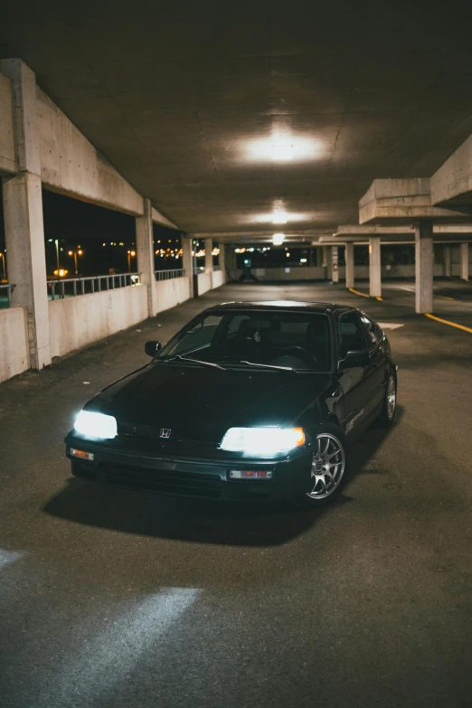 a car is parked in a parking garage, inspired by Hiroshi Honda, unsplash, realism, ✨🕌🌙, honda civic, 1 / 2 headshot, 90's aesthetic
