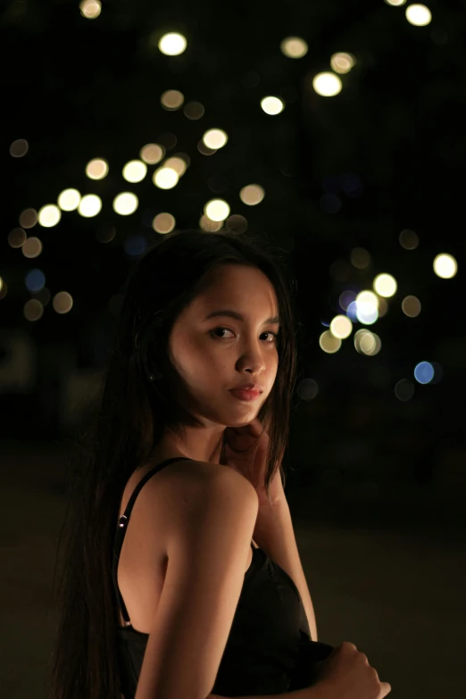 a woman standing in front of a christmas tree, a picture, by Robbie Trevino, unsplash, realism, portrait of modern darna, summer night, model shoot, tourist photo