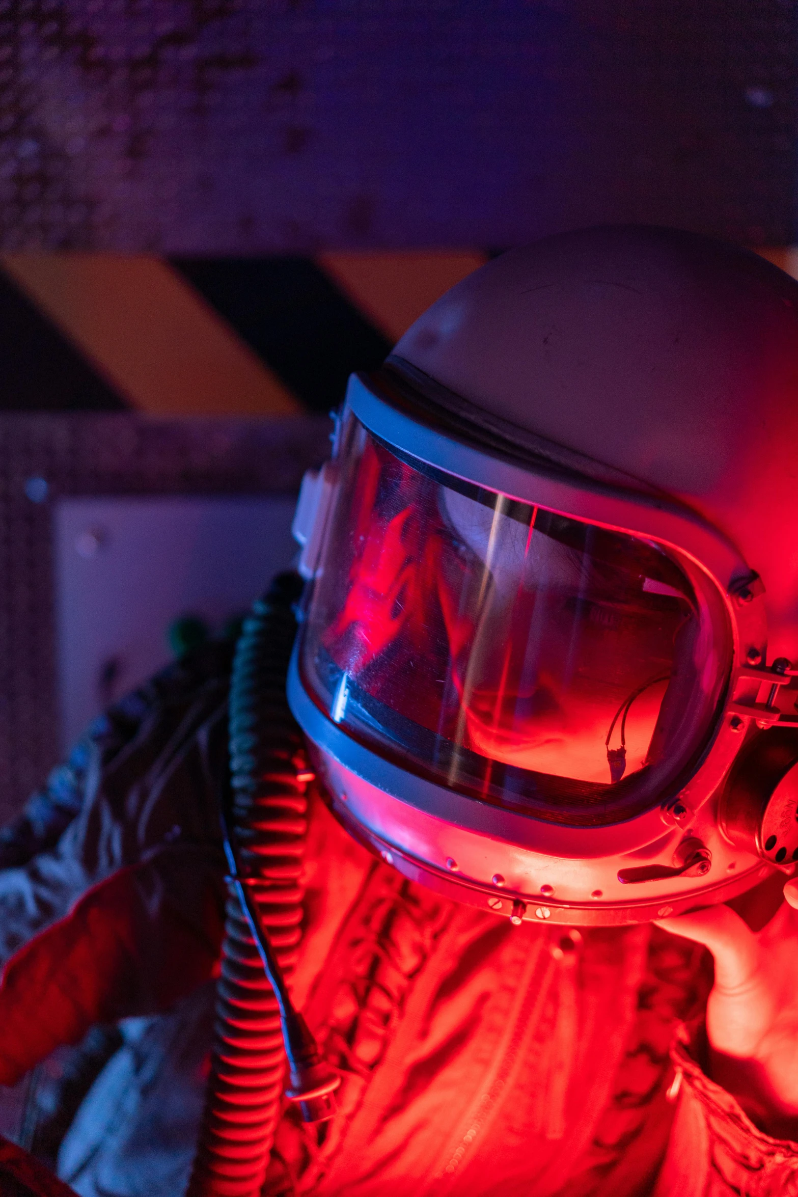 a man in a space suit talking on a cell phone, a portrait, inspired by roger deakins, pexels contest winner, light and space, red lighting, 70's jetfighter pilot, helmet view, beeple. hyperrealism