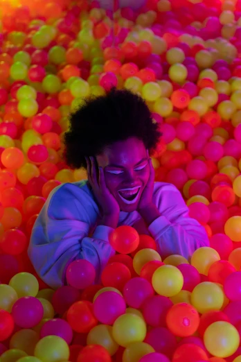 a woman in a ball pit talking on a cell phone, neon glowing eyes, smiling down from above, press shot, neon jungle