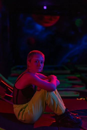 a boy sitting on a bean bag chair in a dark room, inspired by Cindy Sherman, altermodern, in an colorful alien planet, performance, looking serious, photo of young woman