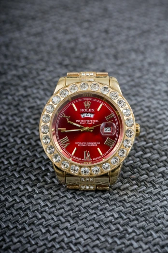 a close up of a watch on a table, a portrait, red and gold, with sparkling gems on top, thumbnail, rap bling