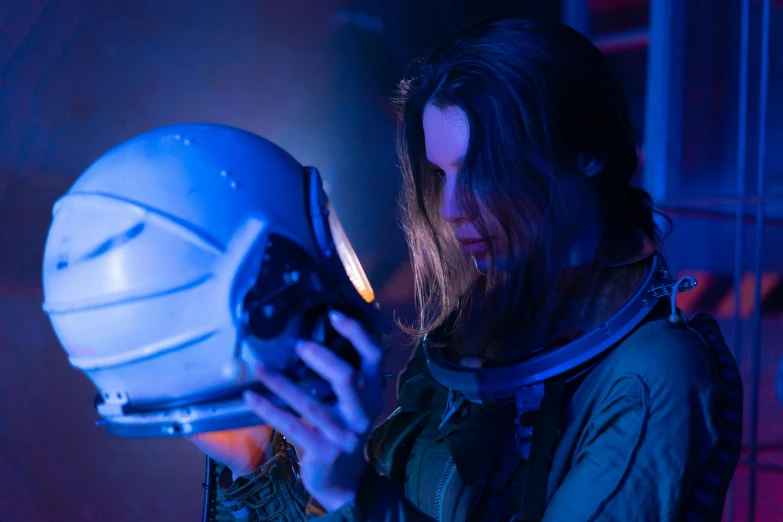 a woman in a space suit holding a camera, a portrait, unsplash, digital art, blue lens airsoft mask, scene from live action movie, low light, profile shot