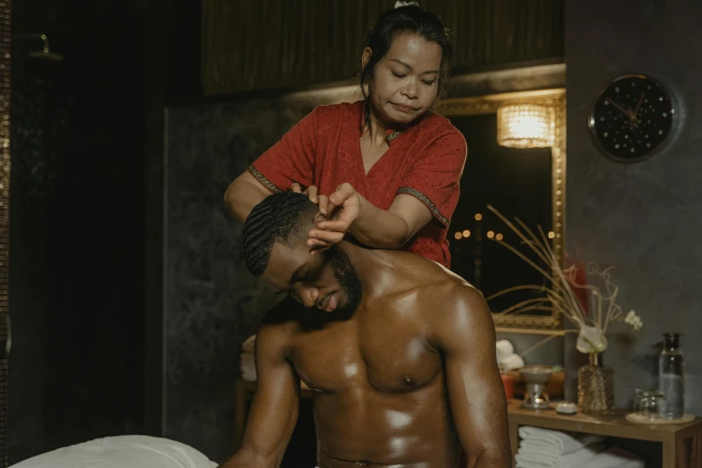 a man sitting on top of a bed next to a woman, serving body, brown skin, asian male, professional image