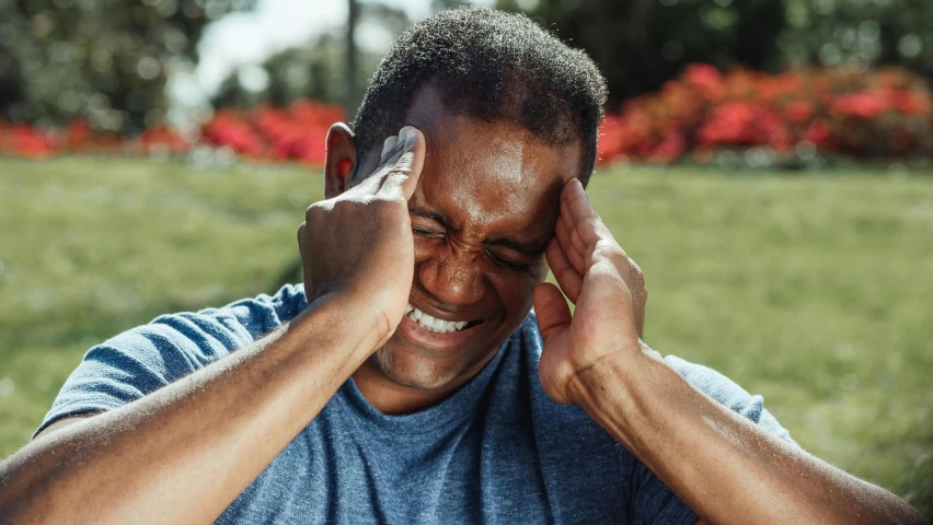 a man covers his eyes with his hands, pexels contest winner, head bent back in laughter, sydney park, tinnitus, thumbnail