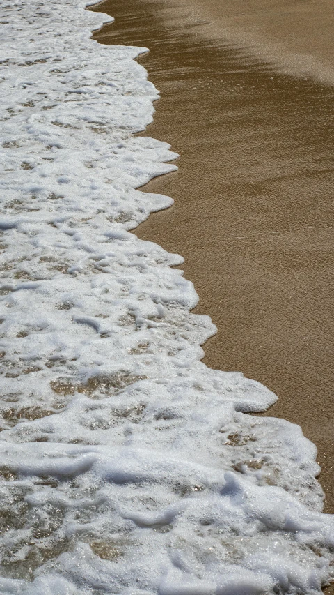 a large body of water sitting on top of a sandy beach, an album cover, unsplash, foamy waves, 15081959 21121991 01012000 4k, detail shot, slide show