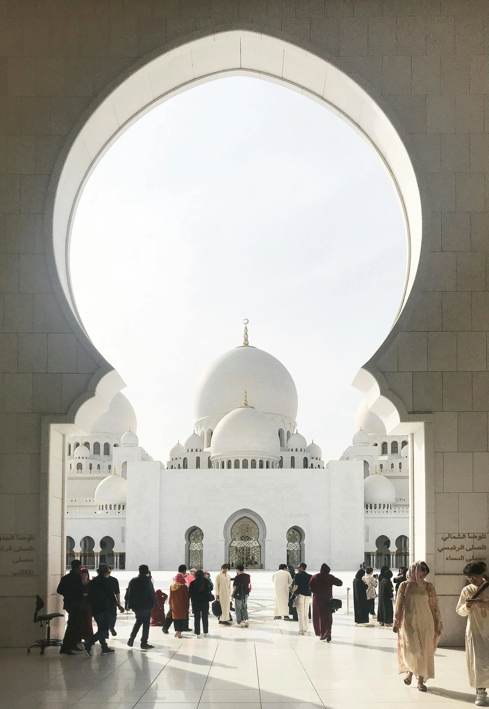 a group of people standing in front of a white building, a picture, by Sheikh Hamdullah, pexels contest winner, hurufiyya, inside a dome, archs, video still, fan favorite