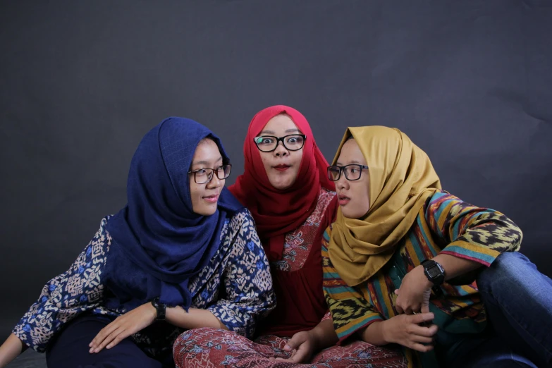 a group of three women sitting next to each other, inspired by JoWOnder, flickr, hurufiyya, studio shoot, background image, with glasses, q hayashida