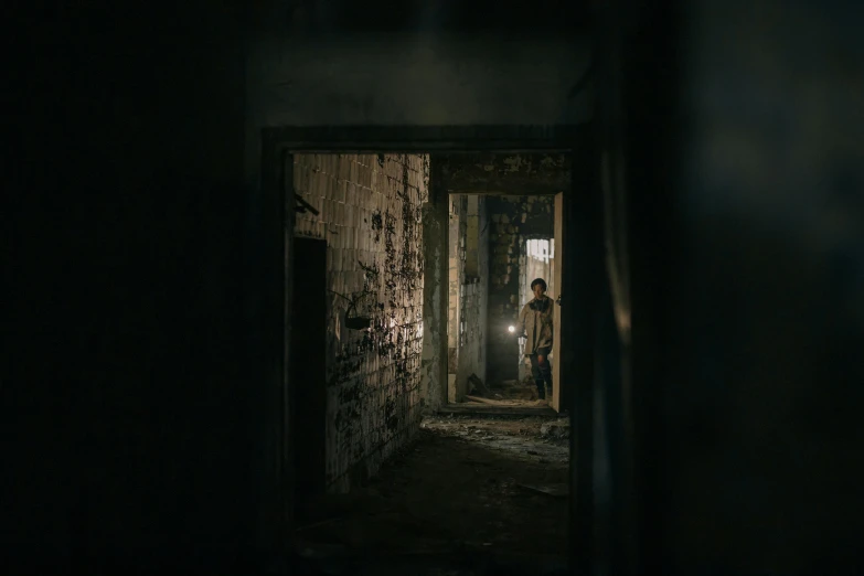 a person standing in a doorway in a dark room, post apocalyptic setting, inside building, from horror movies, dark hallways