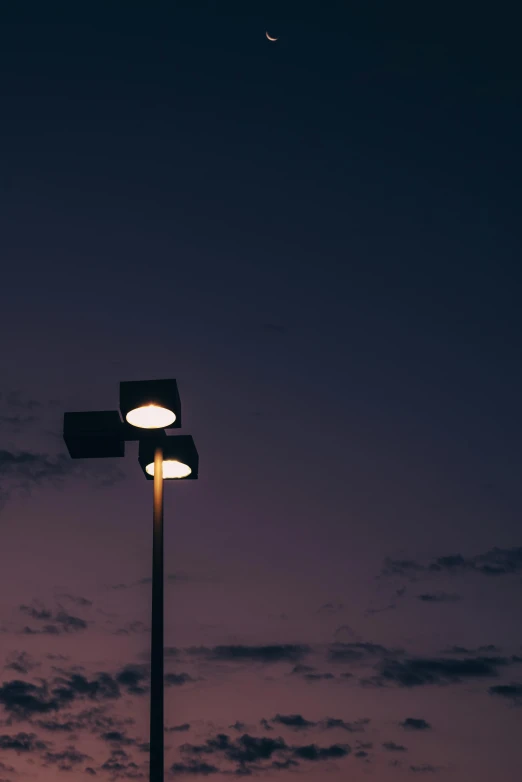 a street light sitting on the side of a road, an album cover, unsplash, postminimalism, violet sky, lamps, parking lot, low angle