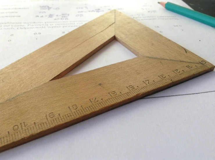 a pair of wooden rulers sitting on top of a piece of paper, by Mathias Kollros, triangle to use spell, student, perfect structure, with a square