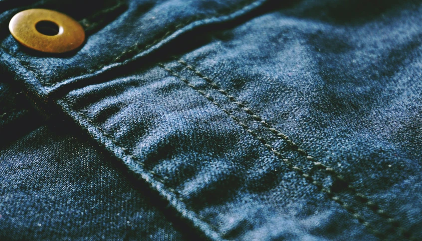 a close up of a button on a pair of jeans, by Niko Henrichon, pexels, renaissance, dark blue and green tones, faded, seams, construction