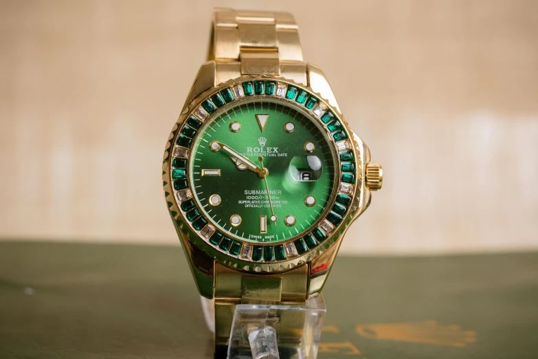 a close up of a watch on a table, a portrait, by Robert Weaver, pexels contest winner, hurufiyya, wearing elaborate green and gold, rolex, with sparkling gems on top, taken in the late 2010s