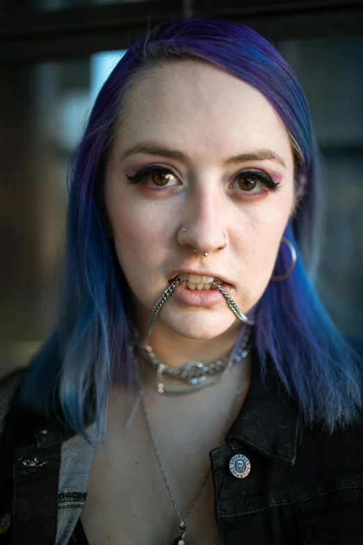 a woman with blue hair and piercings in her mouth, an album cover, featured on reddit, septum piercing, shot with sony alpha, high quality photo, teenager