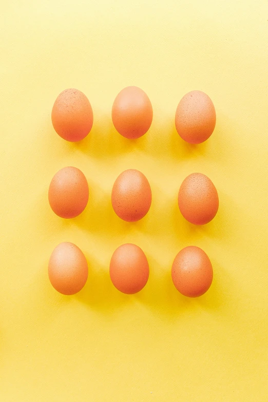 a group of eggs sitting on top of a yellow surface