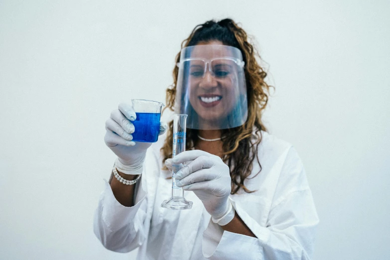 a woman in a lab coat holding a glass of blue liquid, pexels contest winner, renaissance, aida muluneh, dissection of happy, wearing an academic gown, cloning spell