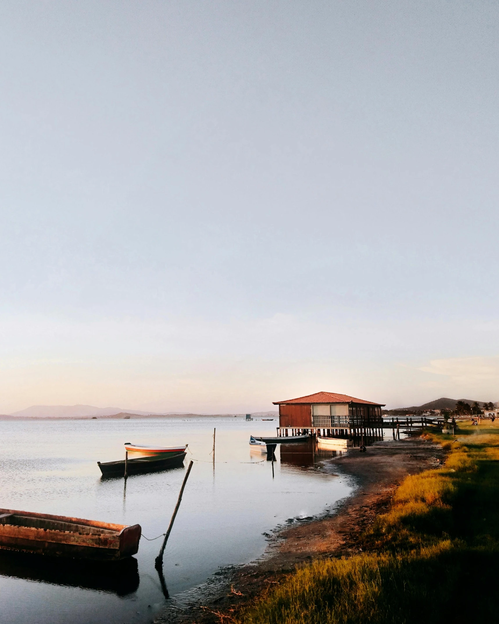 a couple of boats sitting on top of a lake, by Olivia Peguero, panoramic shot, marischa becker, fishing town, landscape photo