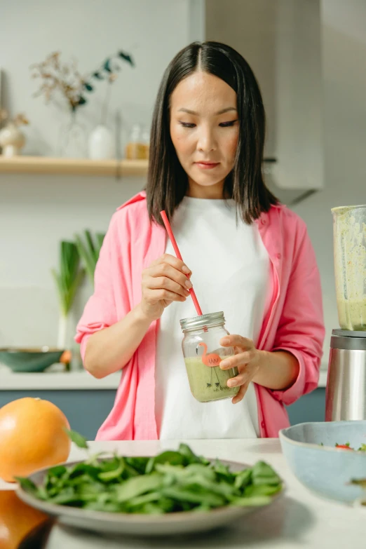 a woman is making a smoothie in the kitchen, pexels contest winner, half asian, promo image, avatar image, casually dressed