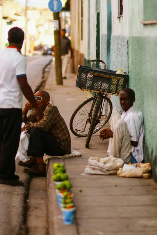 a group of people sitting on the side of a street, flickr, caribbean, fruit, morning mood, square