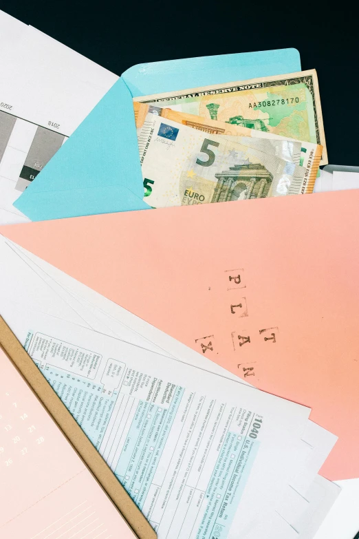 a pile of papers sitting on top of a table, currency symbols printed, thumbnail, flatlay, half image