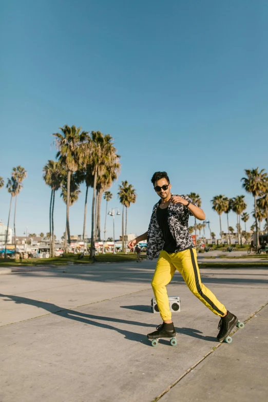 a man riding a skateboard down a sidewalk, by Robbie Trevino, posing on a beach with the ocean, yellow and black, bo chen, palm trees