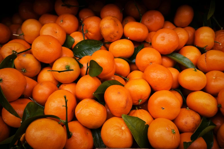 a pile of oranges with green leaves on them, by Tom Wänerstrand, pexels, fan favorite, iphone picture, orange: 0.5, colored fruit stand