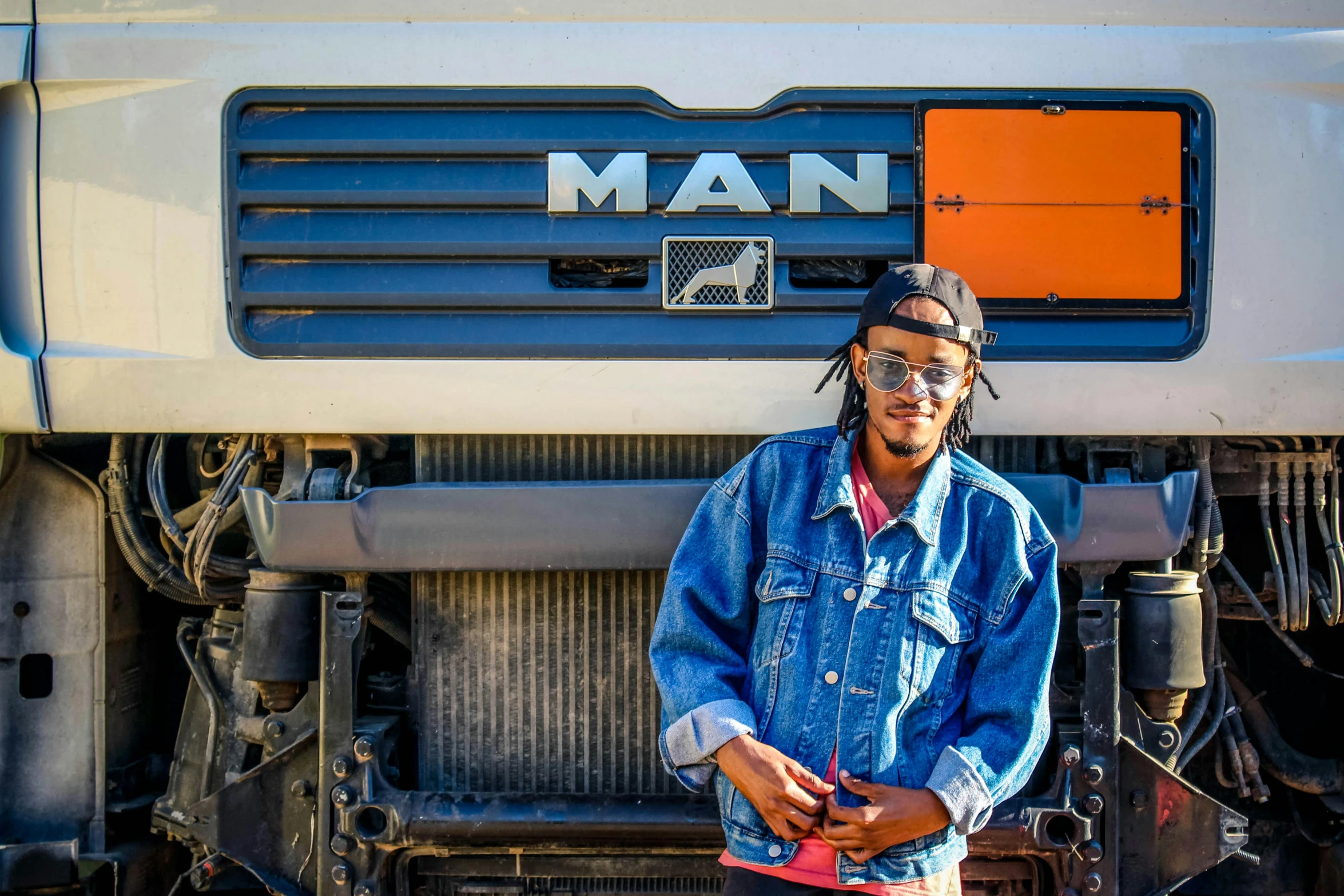 a man standing in front of a truck, by Jan Tengnagel, pexels contest winner, mannerism, afro tech, aboriginal australian hipster, 15081959 21121991 01012000 4k, denim