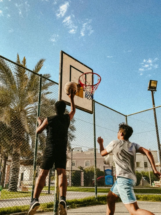 a couple of men playing a game of basketball, pexels contest winner, snapchat photo, in the sun, taken in the late 2000s, enes dirig