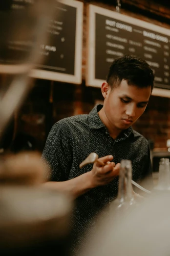 a man looking at his cell phone in a coffee shop, a portrait, by Robbie Trevino, pexels contest winner, banner, tending on arstation, damien tran, aussie baristas