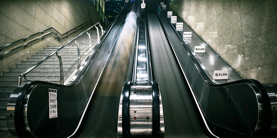 a couple of escalators sitting next to each other, by Daniel Gelon, pexels contest winner, hyperrealism, deserted shinjuku junk, thumbnail, running fast towards the camera, stainless steal